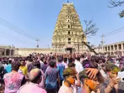 Foreign Tourists Join Hampi's Holi Celebrations at UNESCO Heritage Site