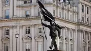 Banksy Unveils Statue of Flag-Wielding Man Poised to Step Off Plinth in London