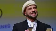 John Travolta Wears Beret at Cannes 2026, Explains Director Look