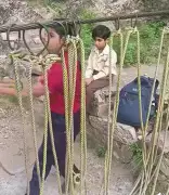 Mandi schoolchildren risk lives crossing dam waters on unsafe swing