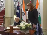 PM Modi Signs Visitors' Book at Government House in Melbourne